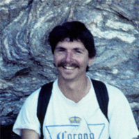 Headshot of Tony Carrasco in front of a rock when he was a student