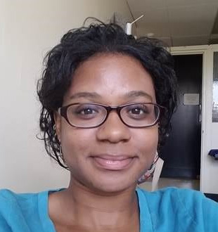 Melissa Sims wearing a blue shirt and glasses