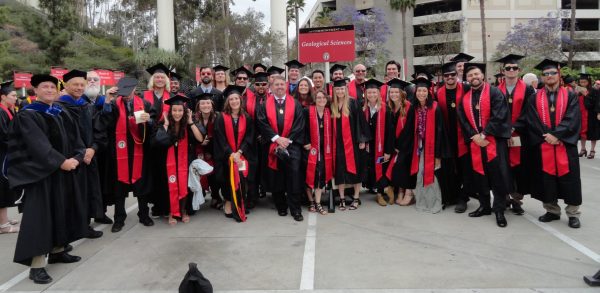 Wasim center left back with fellow graduates at commencement