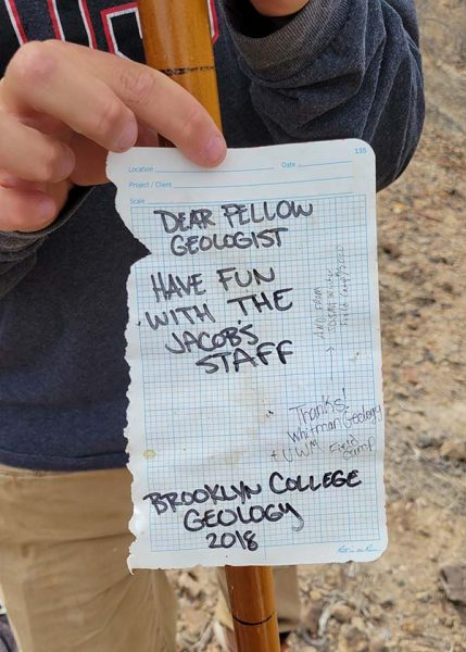 A note that reads "dear fellow geologist, have fun with the Jacob's staff"